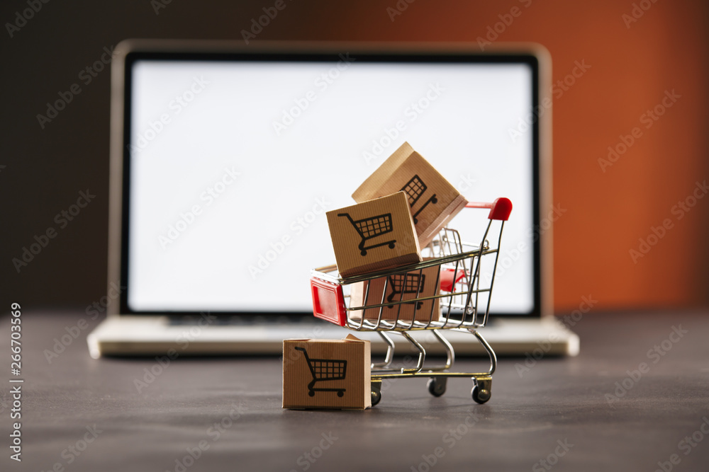 Online shopping. Laptop and boxes on the table