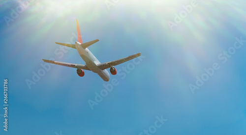 Fototapeta Naklejka Na Ścianę i Meble -  Commercial airplane jetliner flying in blue sky. Passenger aircraft. Travel concept. Copy space
