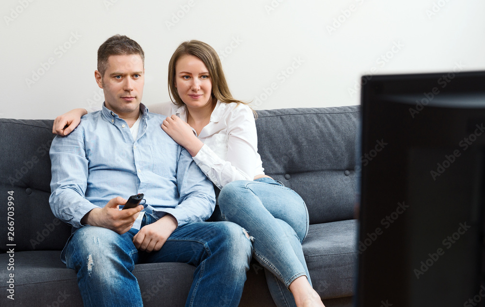 Man and woman watching TV at home. Man and woman watching TV at home.