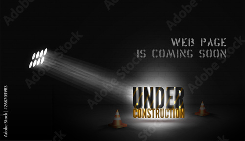 Web page poster Under construction with 3d text in spotlight on scene with cones on black background