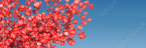 Exploding discount cubes with percent sign in front of blue sky photo