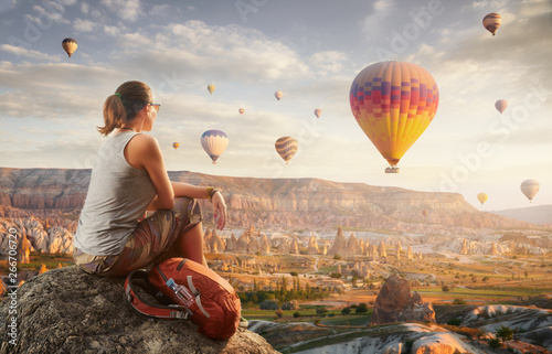 Fototapeta Happy woman traveler watching the hot air balloons at the hill of Cappadocia, Turkey