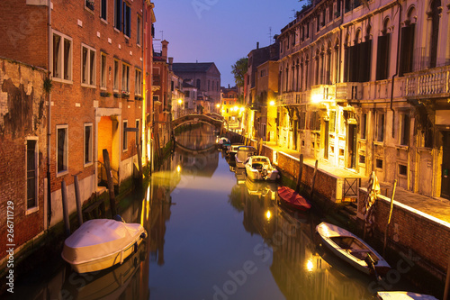 Venice night cityscape with boats in canal, Italy. Venice street illuminated lanterns © dzmitrock87