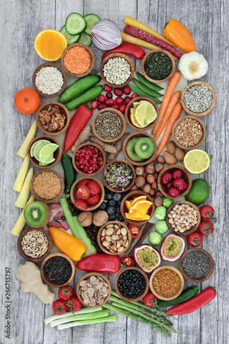 Super food concept for healthy eating including fruit, vegetables, cereals, nuts, seeds, herbs, spices and legumes, Foods high in antioxidants, anthocyanins, dietary fibre and vitamins.