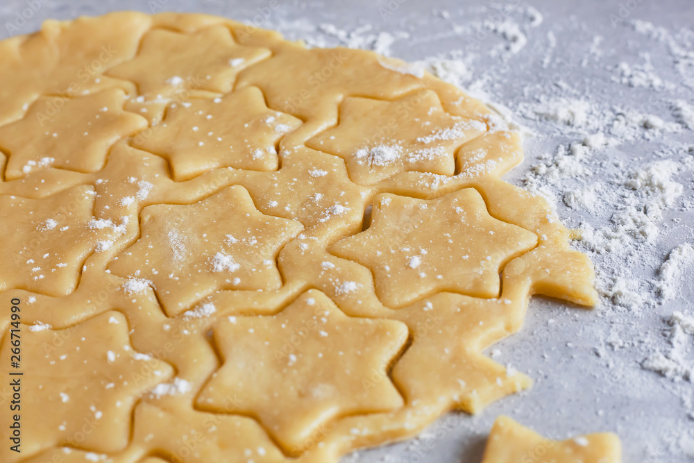 Dough for baking. The process of making cookies and gingerbread at home. Star shaped cookies Dough for baking. The process of making cookies and gingerbread at home. Star shaped cookies