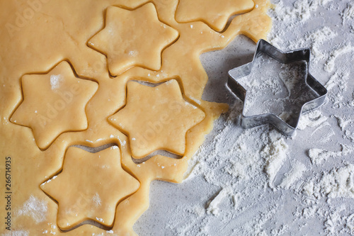 The process of baking cookies at home. Cookie dough. Star-shaped cookies, sliced ​​festive sugar cookies. Spicy cookies.