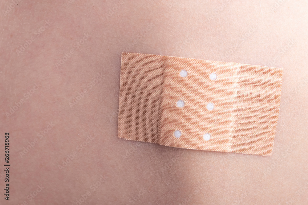 Medical Adhesive plaster on a person's back Medical Adhesive plaster on a person's back