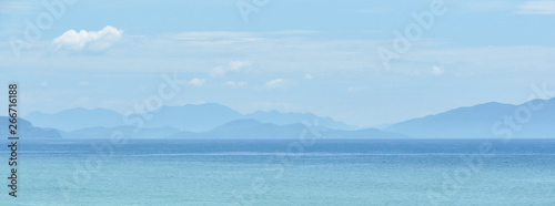 Obraz na płótnie blue warm landscape background tropical sea mountains silhouettes. Copy space for text w salonie