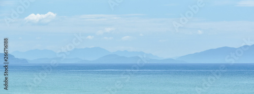 blue warm landscape background tropical sea mountains silhouettes. Copy space for text