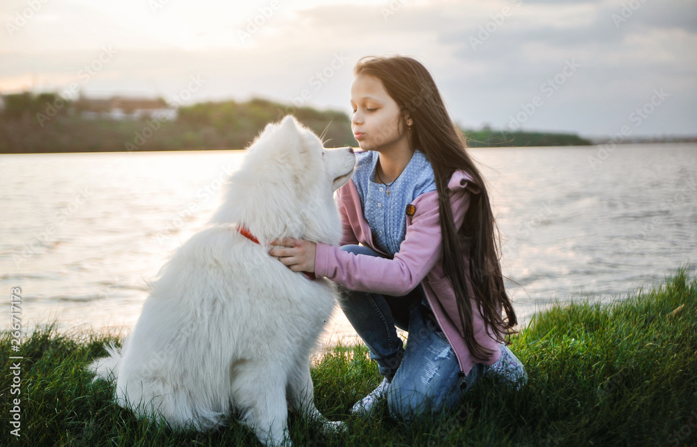 Cute girl with a dog on the grass. Friendship concept. Cute girl with a dog on the grass. Friendship concept.