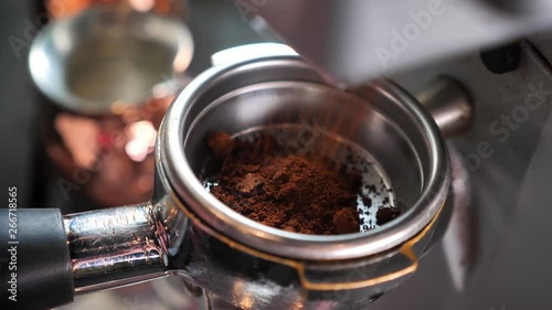 Closeup shoot of coffee beans being freshly grounded in a coffee blending machine indoors in a cafe