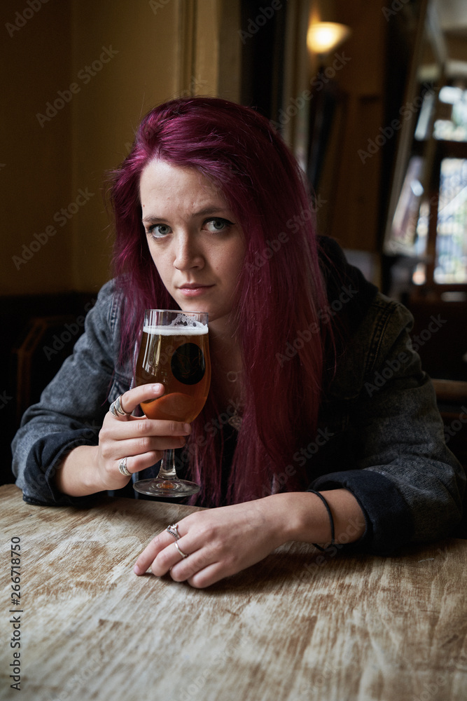 Emo girl drinking alone in the pub