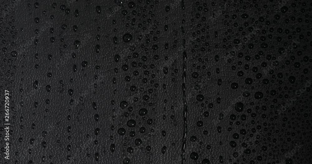 Water rain drop falling on shiny luxury black lather background Water rain drop falling on shiny luxury black lather background