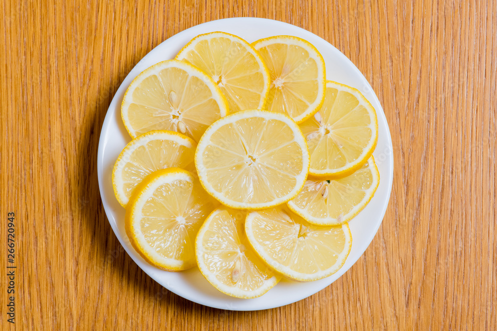 Fresh yellow lemons slices on a wooden background.. sweet lime, vitamin c. Lemon slices Fresh yellow lemons slices on a wooden background.. sweet lime, vitamin c. Lemon slices