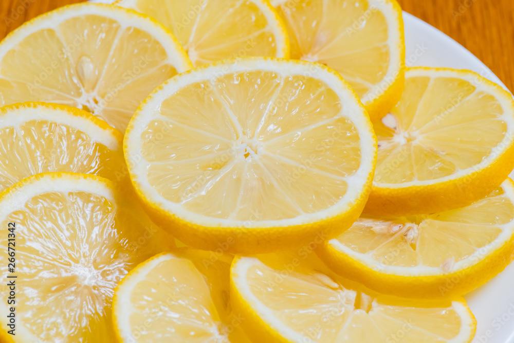 Fresh yellow lemons slices on a wooden background.. sweet lime, vitamin c. Lemon slices Fresh yellow lemons slices on a wooden background.. sweet lime, vitamin c. Lemon slices