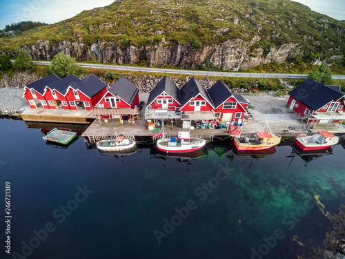 Norwegian traditional red houses over the water in the bay photo