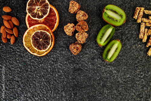 Healthy snacks -  variety oat granola bar,  rice crips, almond,  kiwi, dried orange