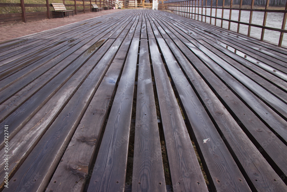 long wooden platform on the river Bank long wooden platform on the river Bank