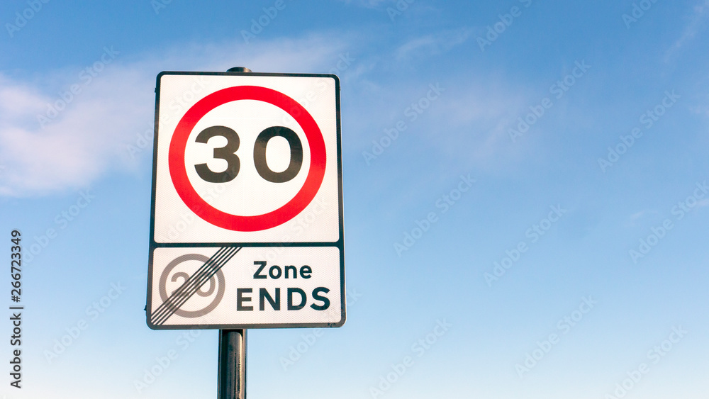 Traffic Road sign for 30mph (miles per hour) speed limit zone and end of 20 mph speed limit zone in England Traffic Road sign for 30mph (miles per hour) speed limit zone and end of 20 mph speed limit zone in England