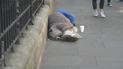 A homeless man sleeping on the street. photo