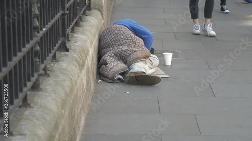 A homeless man sleeping on the street.