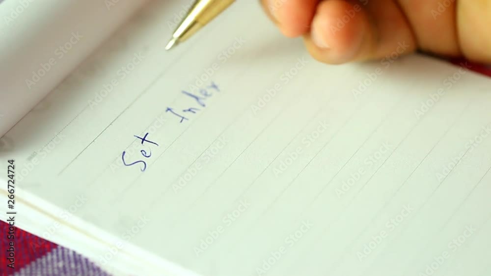 Man writing set index of stock exchange on the notebook. Chiangmai Thailand Man writing set index of stock exchange on the notebook. Chiangmai Thailand