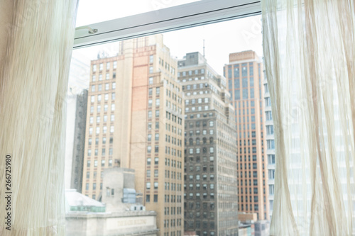 New York City, USA urban cityscape building skyscrapers in NYC Herald Square vintage view through window and curtains