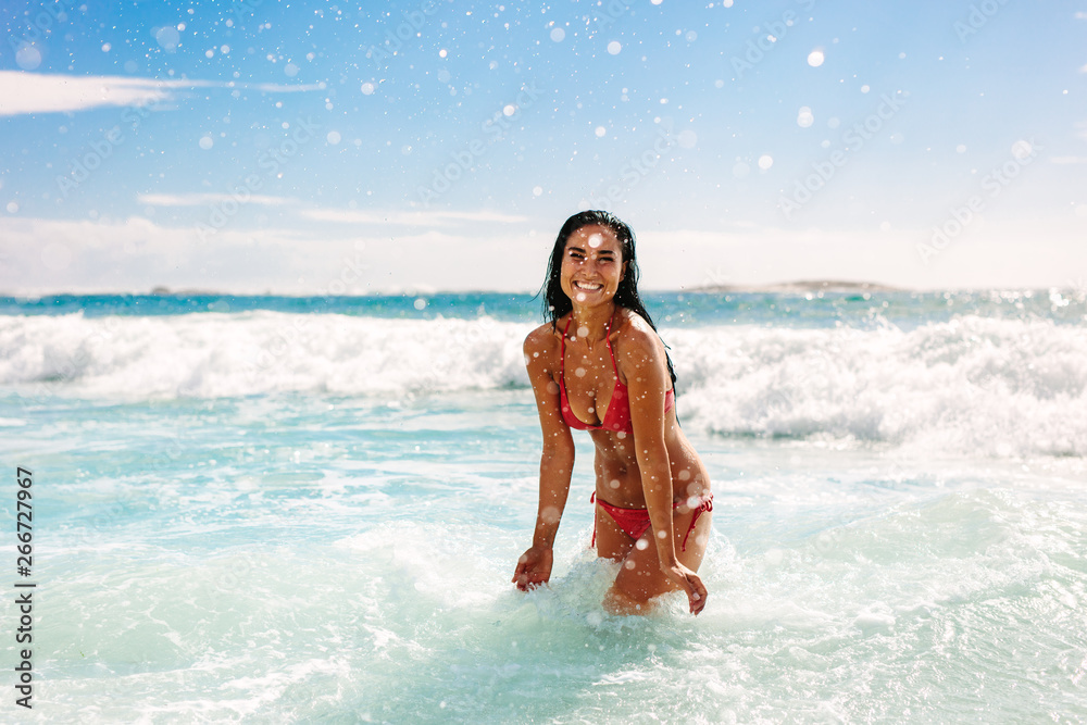 Woman on vacation playing at the beach