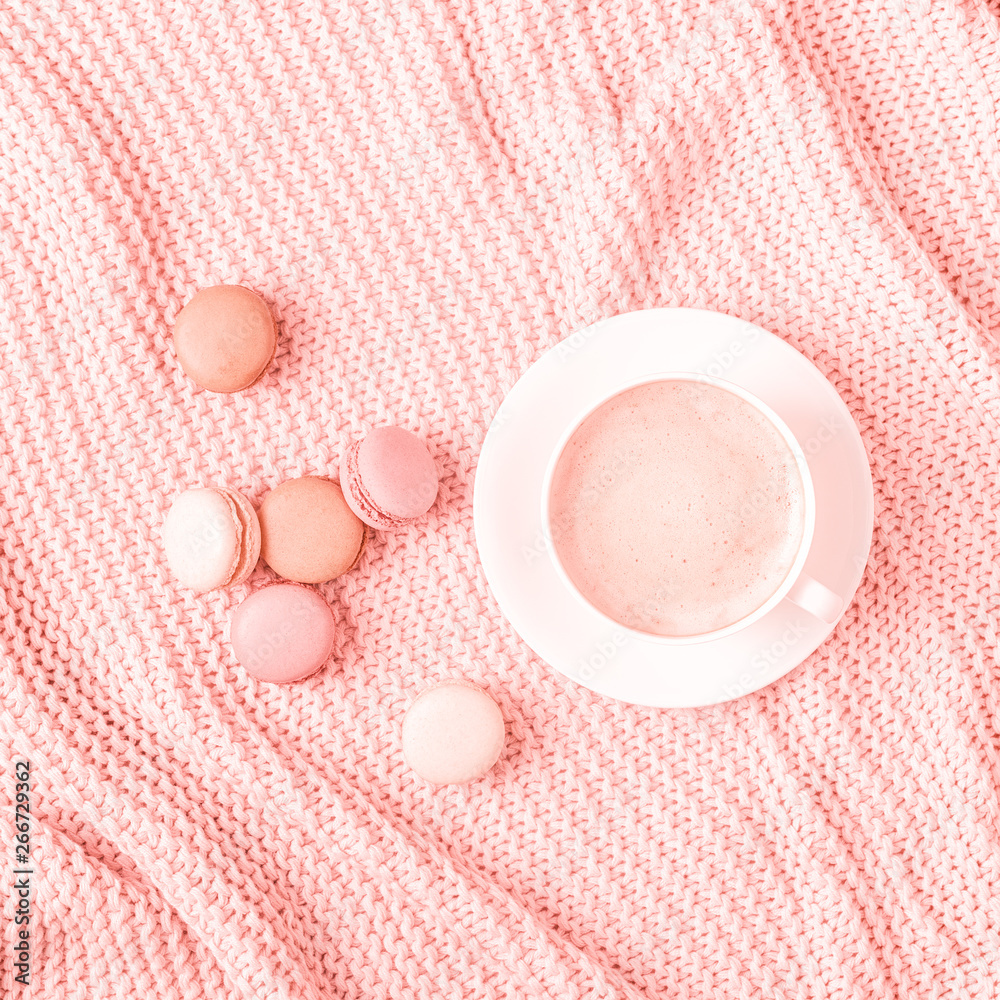 Background with pink plaid, coffee and macaroons.