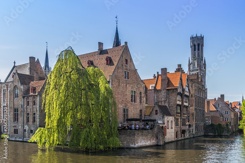 Beautiful canal and traditional houses in the old town of Bruges photo