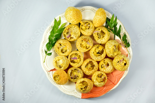spicy and delicious home made pani puri plate on white background