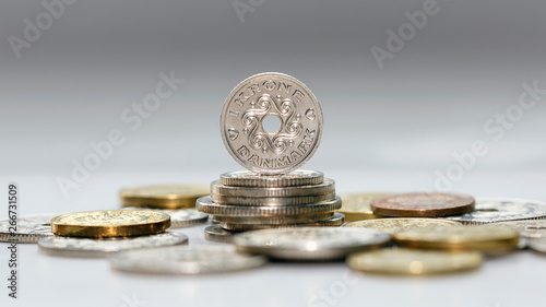Selection of mixed Danish Kroner coins with selective focus - The Krone is the official currency of Denmark.