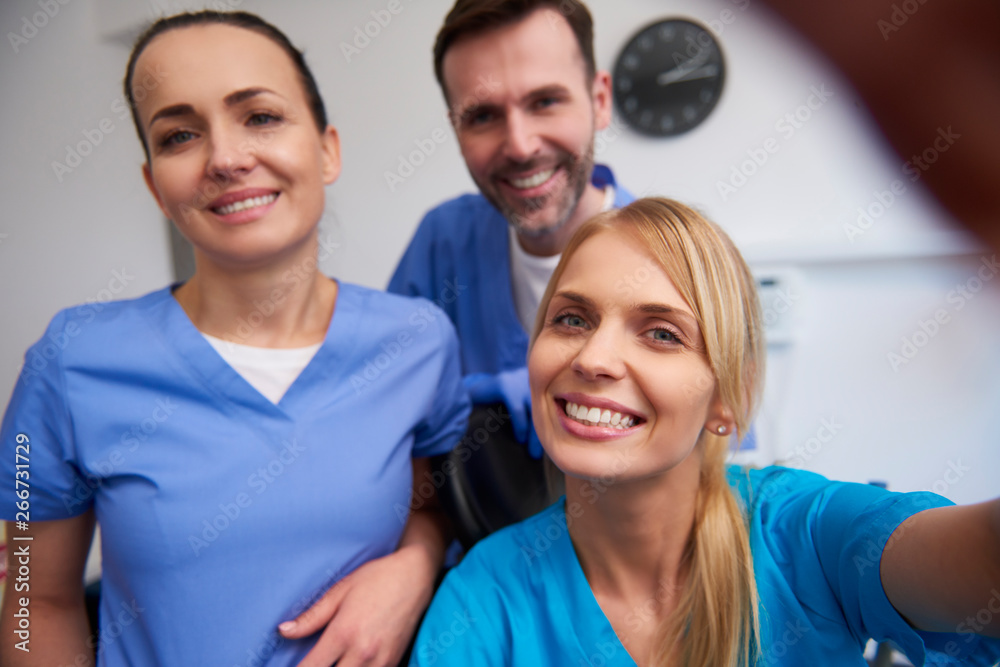 Team of smiling dentists in dentist's office Team of smiling dentists in dentist's office