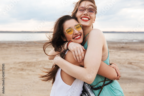 Two cheerful young girls friends