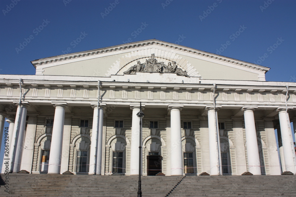 white building facade with columns and bas-reliefs   
