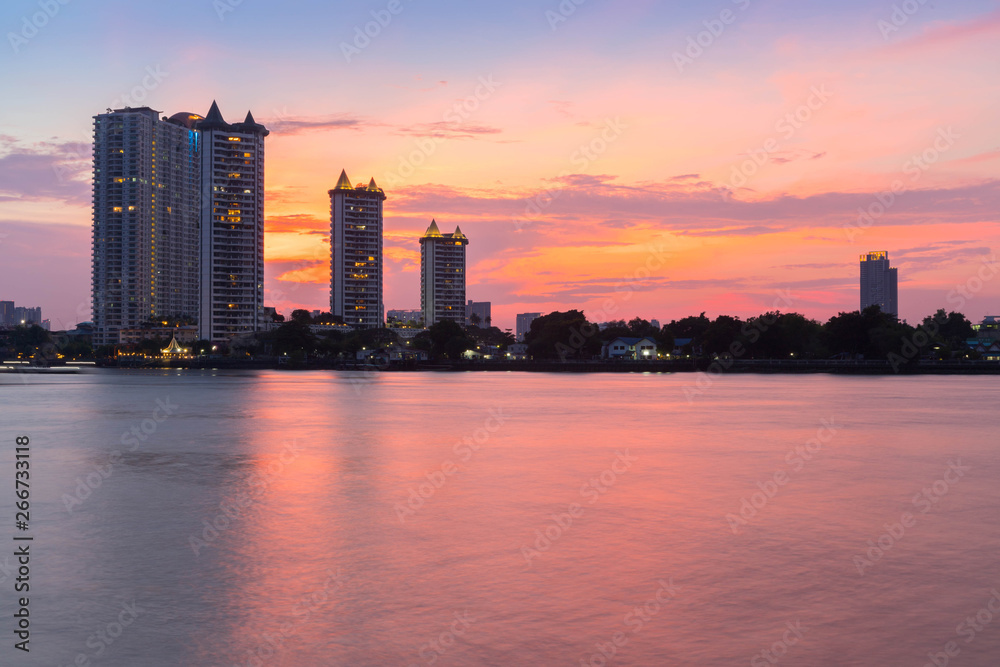 Modern buildings condominium at Chao Phraya River Bangkok Thailand at sunrise.