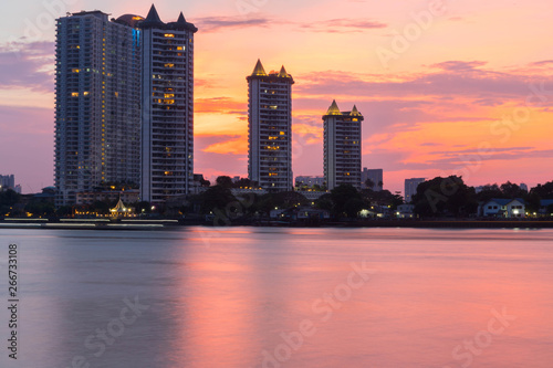 Modern buildings condominium at Chao Phraya River Bangkok Thailand at sunrise. photo