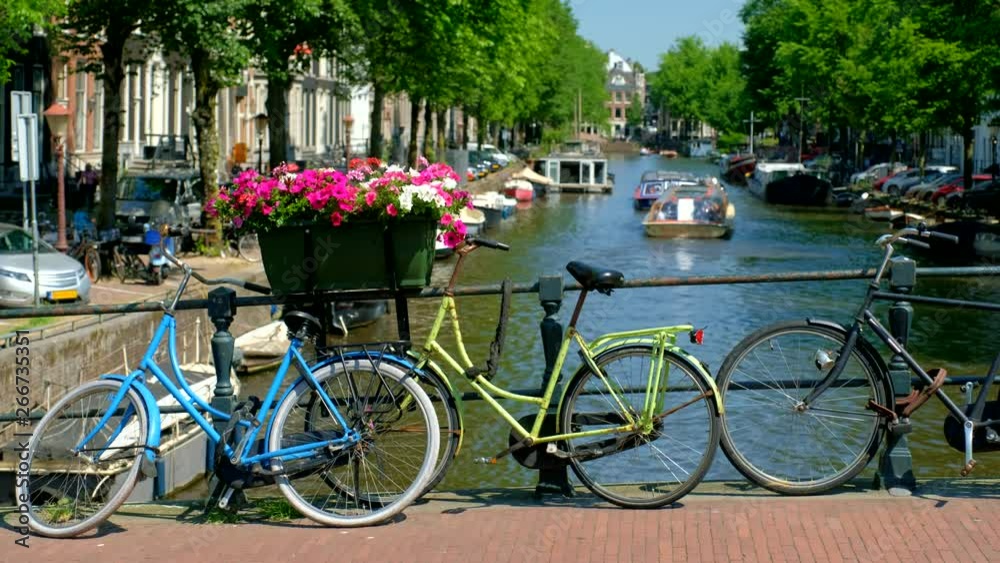 Amsterdam canal with boats and bicycles on a bridge