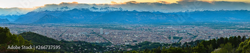 Aerial view on Turin city from the hills, sunset landscape and city skyline with Alps on backround