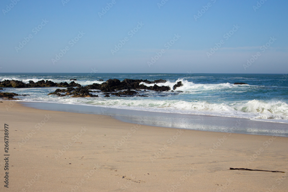 Waves crashing on rocks on Atlantic Ocean beach. Scenic seascape. Beautiful surf at seaside. Splashing waves with foam. Travel and vacation on shore. Rocky coastline. Nature power. Waves crashing on rocks on Atlantic Ocean beach. Scenic seascape. Beautiful surf at seaside. Splashing waves with foam. Travel and vacation on shore. Rocky coastline. Nature power.