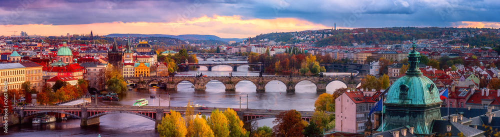 Sunset in Prague panorama, view to the historical bridges, old town and Vltava river from popular view point in the Letna park, autumn landscape in sunset light with amazing cloudy sky, Czech Republic