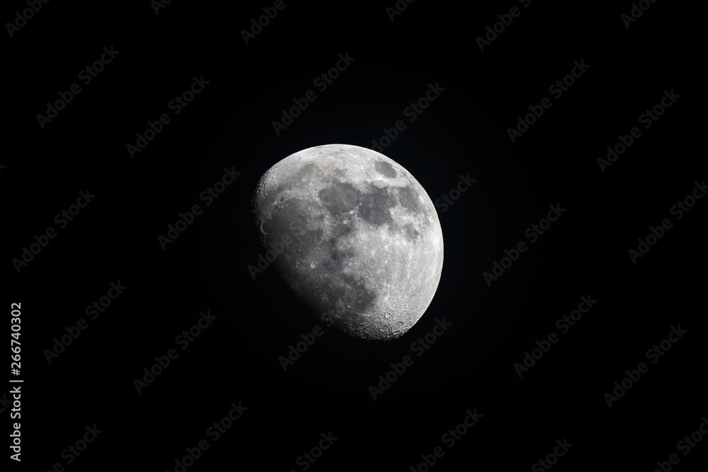 The earths moon as seen through a telescope on a clear night The earths moon as seen through a telescope on a clear night