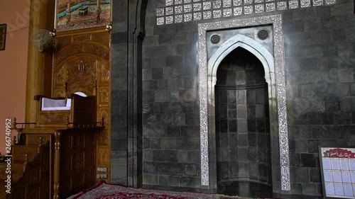 Extreme close-up low-angle still shot of a decorated Mihrab on a wall, indicating the direction of Kabaa in Mecca, Jamia Masjid mosque,  Srinagar. photo