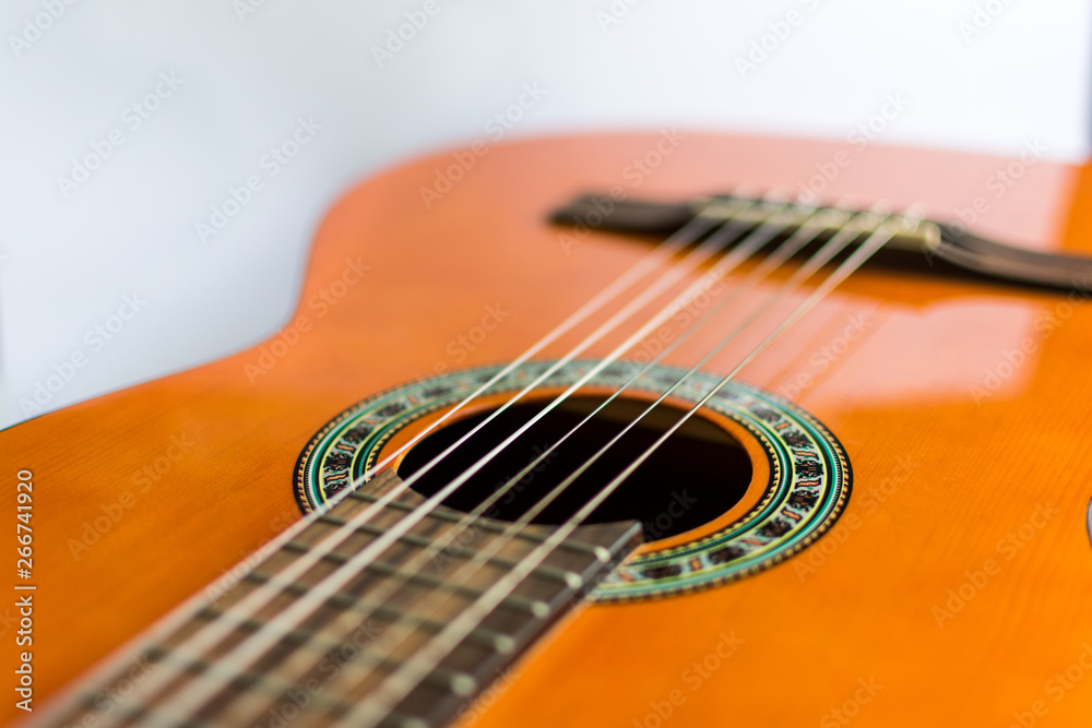 Classic acoustic guitar on white background view.
