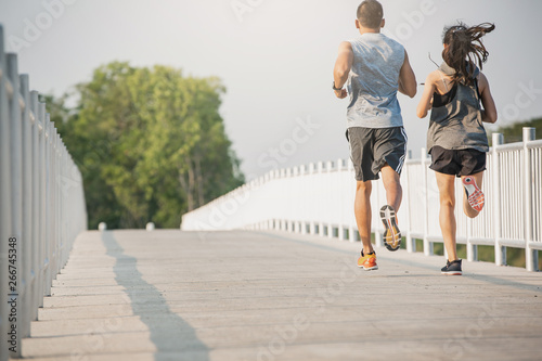 Young couple running on the street be running for exercise. fitness, sport, people, exercising ,running and lifestyle concept . © Sirichai