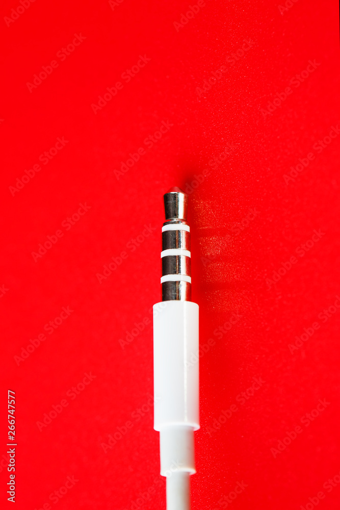 White connector AUX white cable on a red background
