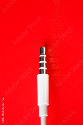 White connector AUX white cable on a red background