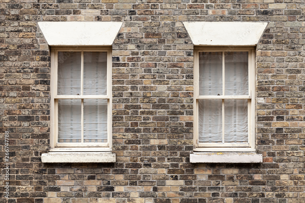 Two similar windows in brick stone Two similar windows in brick stone