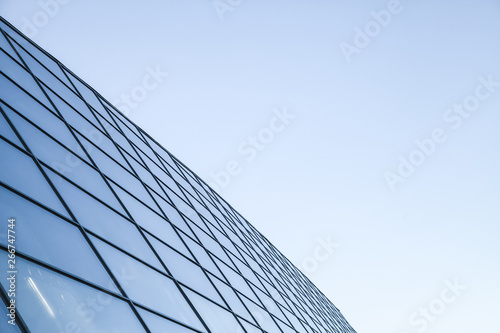 Shiny glass wall under blue sky