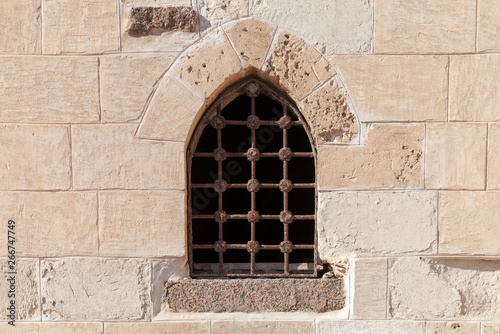 Old fortress stone wall with window